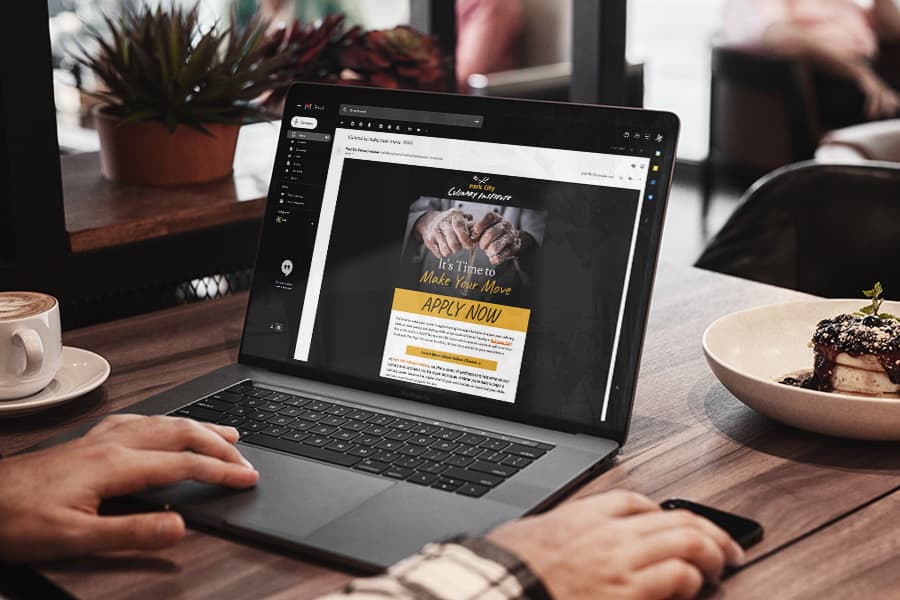 Recipient viewing an email designed and deployed for a client on their laptop in a cafe.